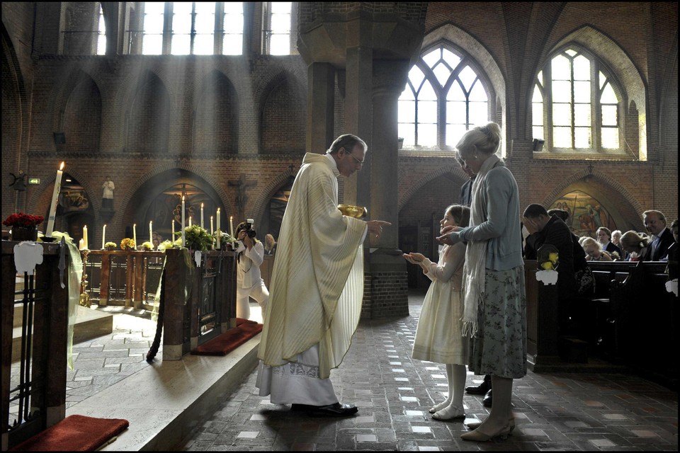 De Larense pastoor Jan Vriend tijdens een eerste communie enkele jaren geleden.