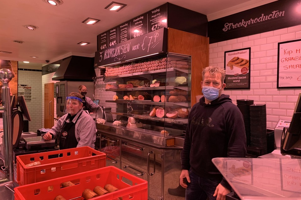 De laatste klanten worden maandagmiddag nog bediend in slagerij Jeroen de Vries. Rechts eigenaar Bas Gelijk.