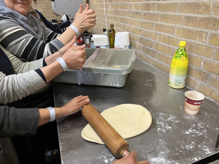 A group of female residents bakes Lebanese bread.