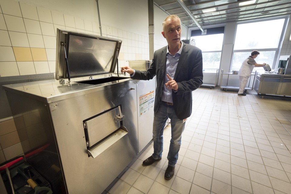 Fedor Veldmaat demonstreert de composteermachine in het Alrijne-ziekenhuis.